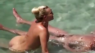 Nudist couple refreshing in the water